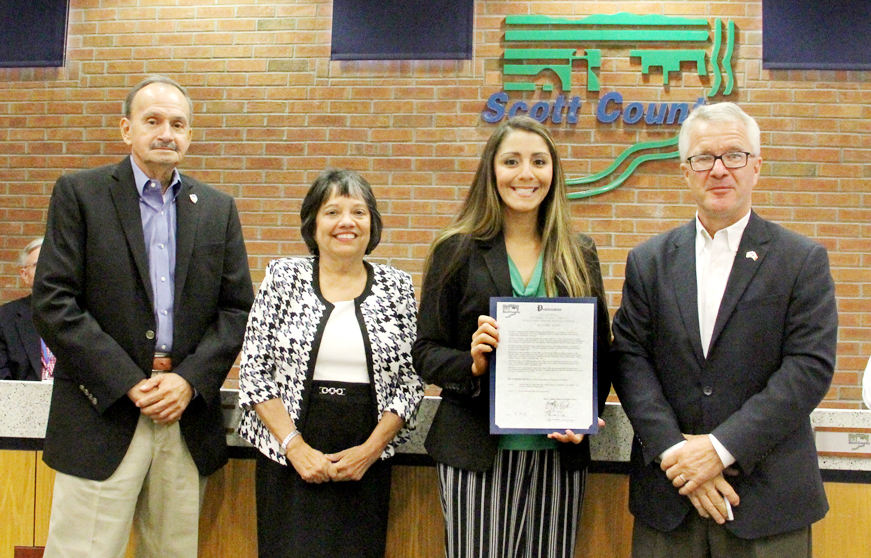 Attorney Newton-Butt accepts a proclamation on behalf of LULAC from the Scott County Board of Supervisors